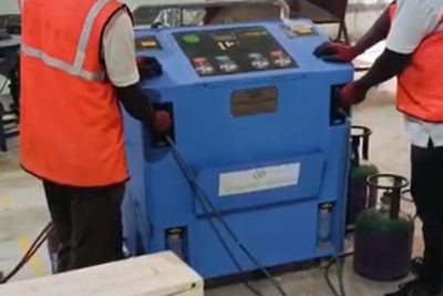 E-waste processing - Workers operating industrial machine